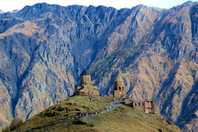 Gergeti Trinity church on its ridge below the Caucasus wall at Stepantsminda
