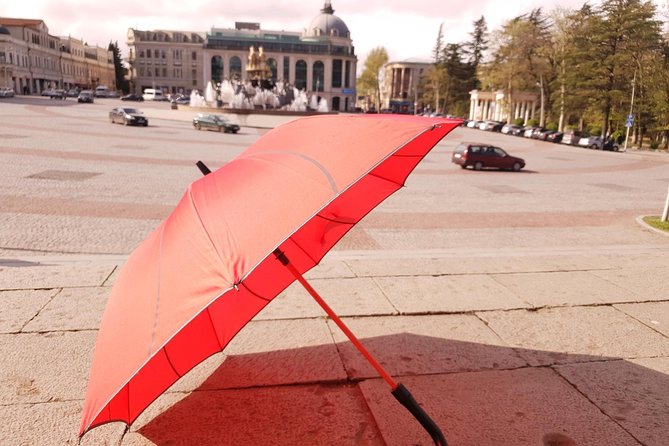 Kutaisi Walking Tour - Finding your guide at the central fountain, red umbrella and all